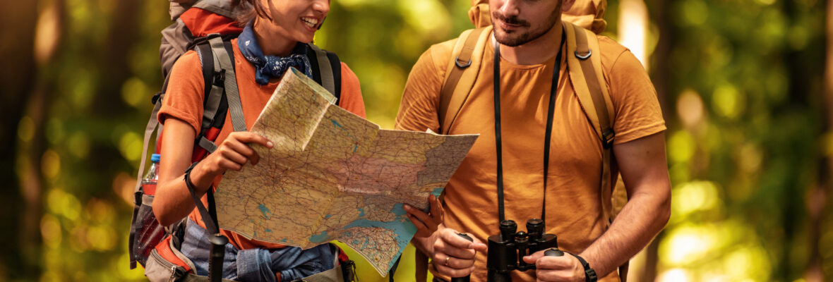 Cheerful couple hiking together in forest