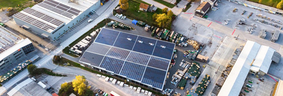 Industrial warehouse with solar panels in the countryside aerial view